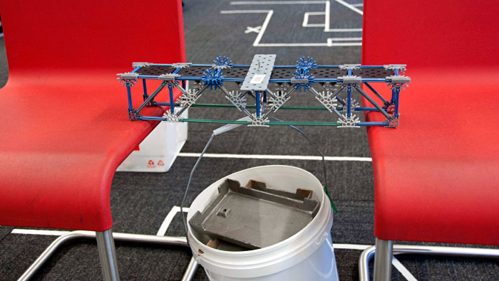 Bridge across 2 chairs, suspending weights