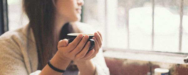 Girl holding coffee cup