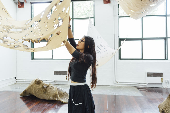 Yumemi Hiraki installing work at the 2015 Art Graduate Exhibition. Photo: Drew Echberg.