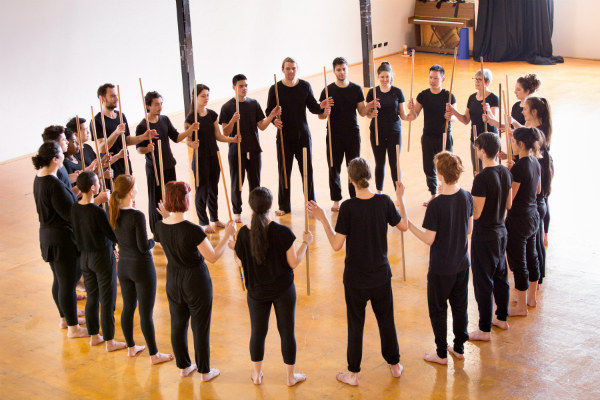 Performers standing in a circle